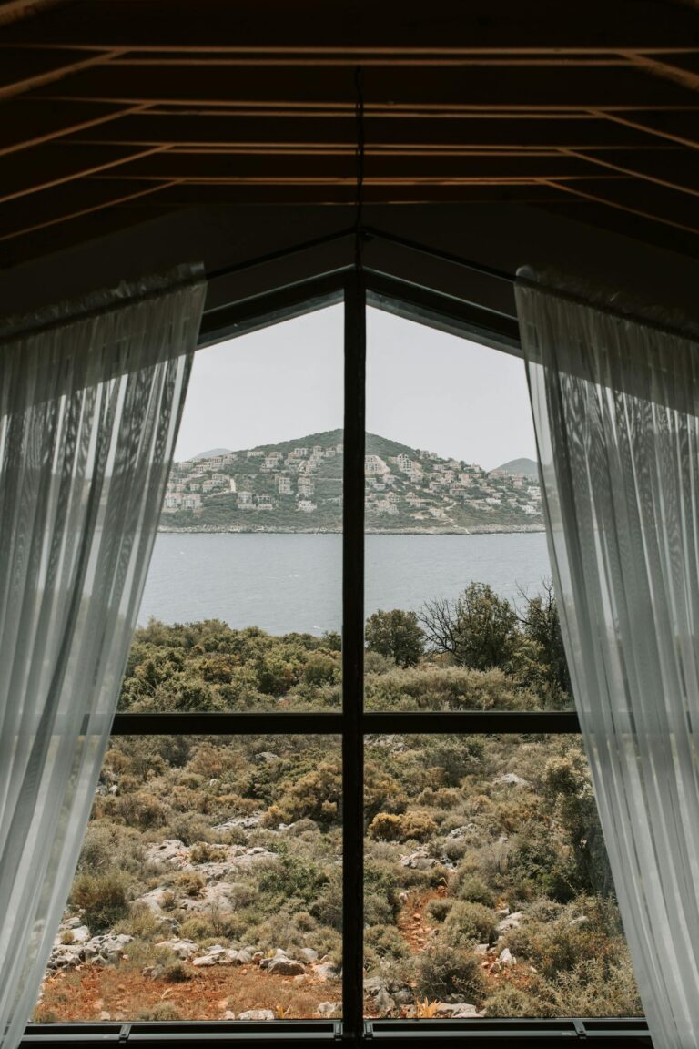 View Of The Sea From Window With White Curtain 